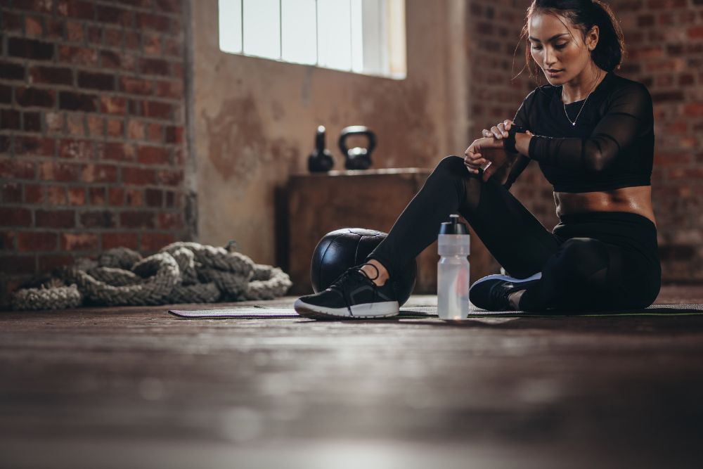 Frau nach dem Training auf einer Bodenmatte